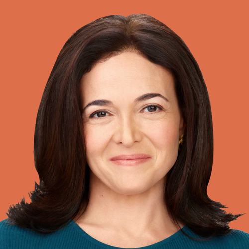 A woman with shoulder-length dark brown hair and light eyes smiles softly, wearing a teal top and gold earrings, photographed against a warm orange background in a professional headshot style.
